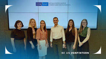 Six interns smile and stand in line